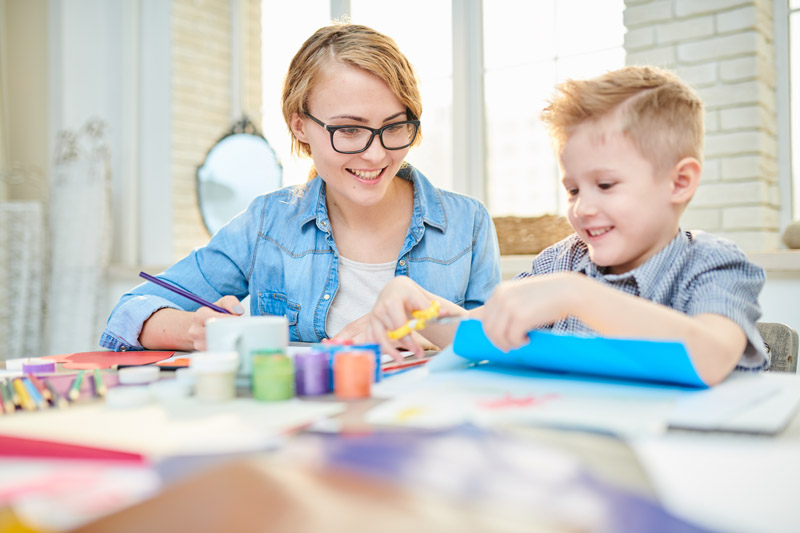 mother-and-son-crafting-together-at-home-LTK34BD.jpg